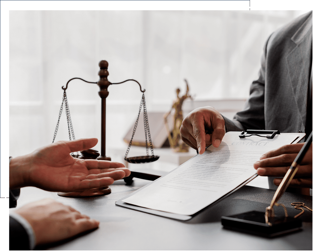Lawyer discussing legal documents with client in office.