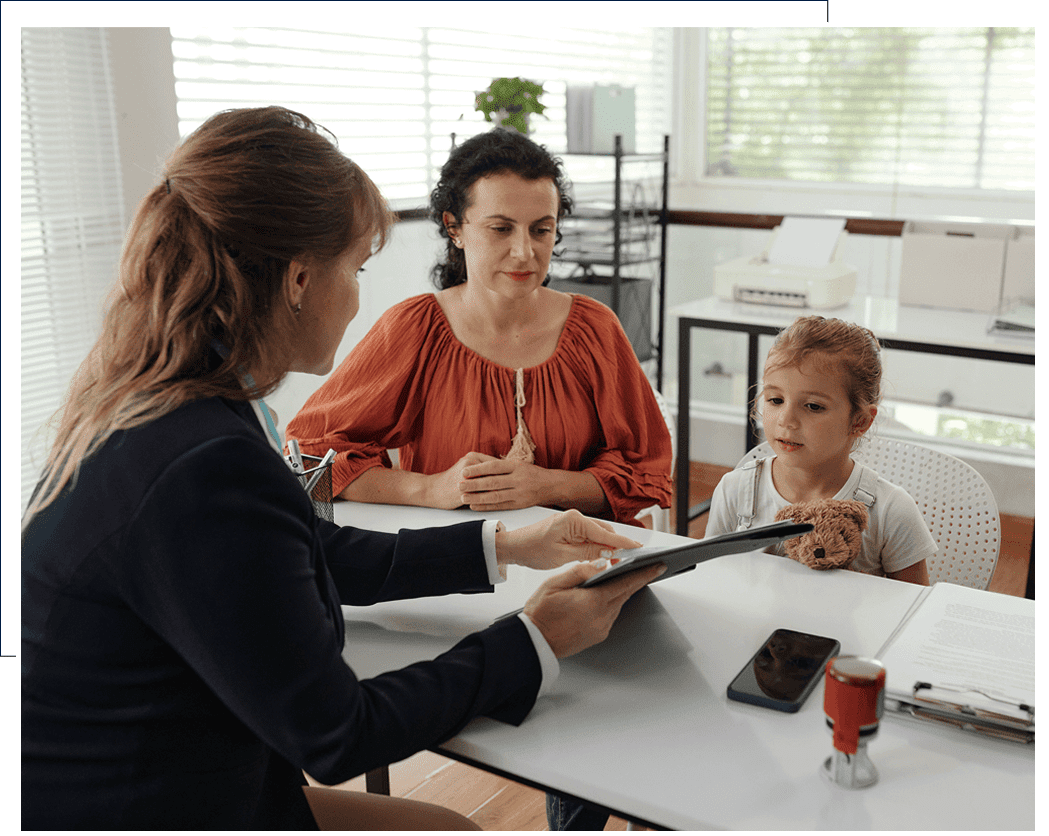 A family consulting a professional at an office desk.
